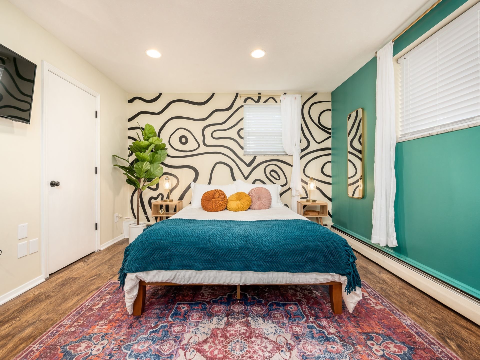 Bedroom with a hand-drawn mural and teal accents