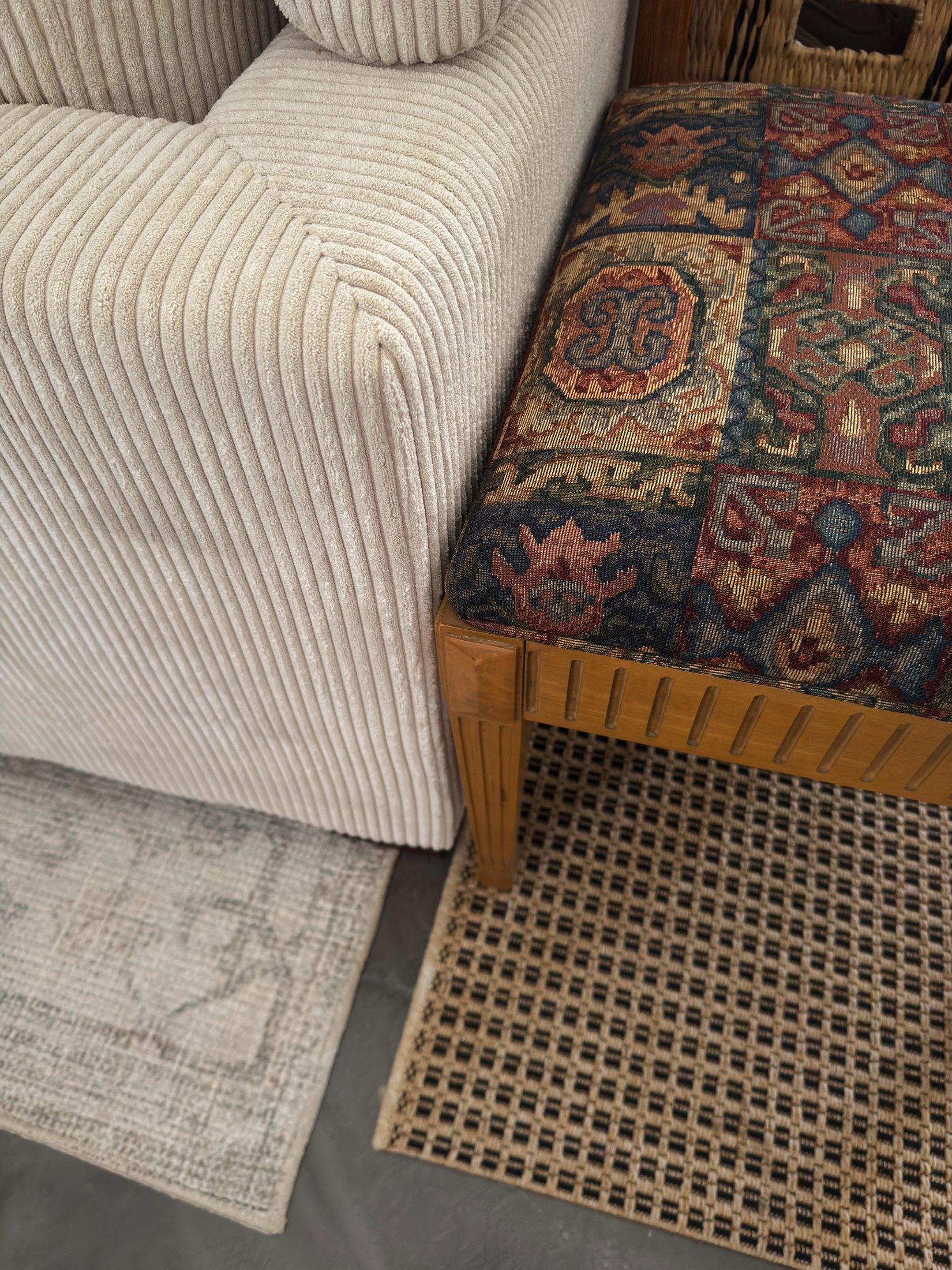 Layered upholstery, woven cane, and patterned textile detail